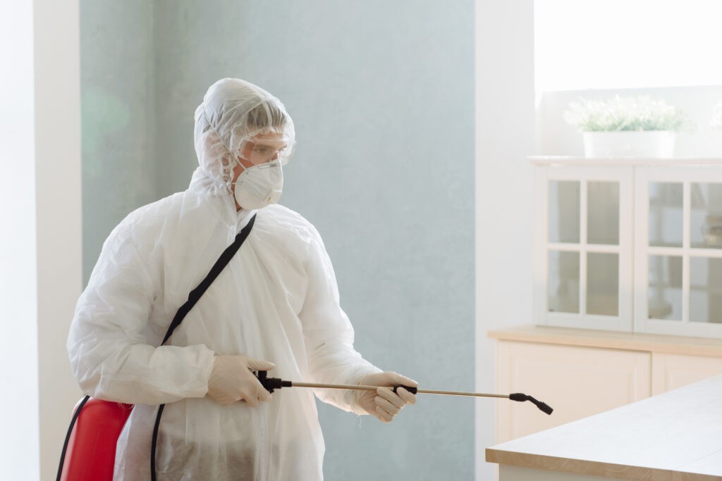 A professional contractor disinfecting the area